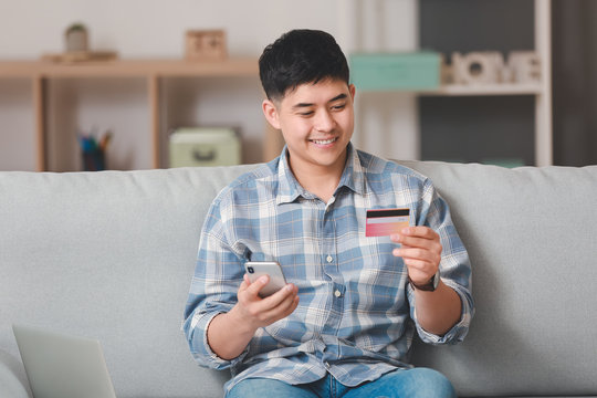 Asian Man Shopping Online At Home