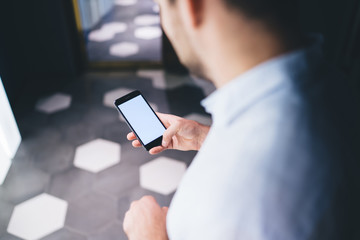 Crop manager using smartphone in office corridor