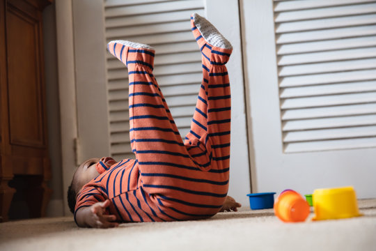 Baby doing yoga exercises during home quarantine 