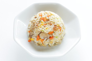 Chinese food, chicken and carrot fried rice on white plate