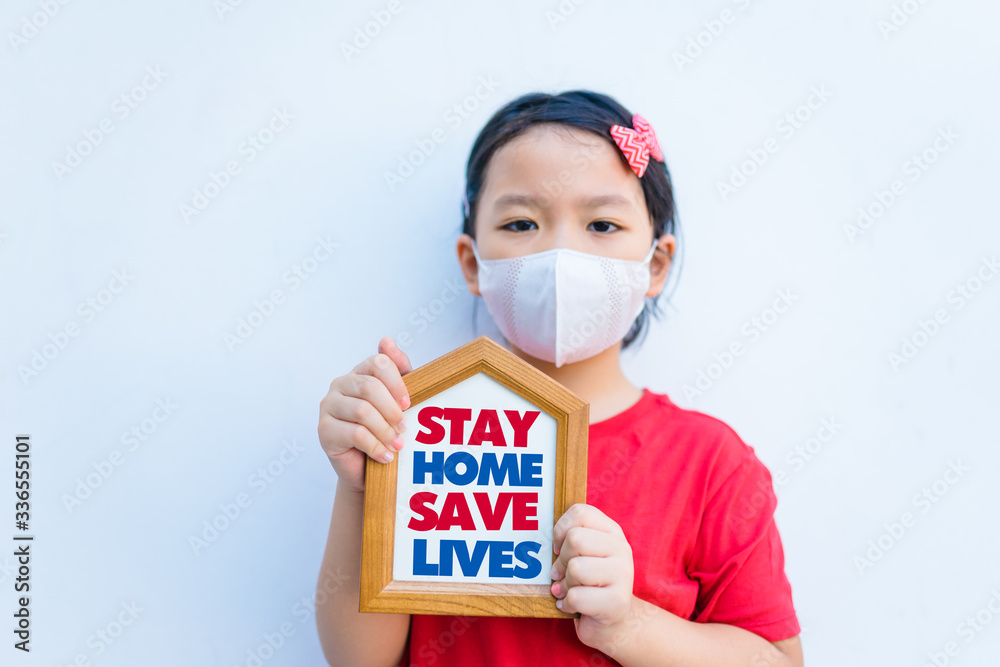 Wall mural Stay home save lives.Covid-19 Coronavirus.Stay Learning from home, Social distancing.Happy little asian girl showing home sign.Stay home save lives.Lockdown and Quarantined for control infection.