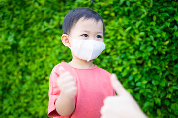 Coronavirus Covid-19 and Air pollution concept.Chinese boy and chinese mother wearing mask for protect pm2.5 and virus corona Covid19 when go outside.Pandemic coronavirus and epidemic virus symptoms.