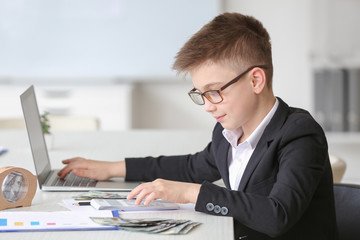Little accountant working in office