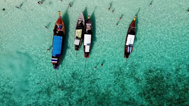 PHI PHI DON, THAILAND - DECEMBER 24, 2019: Aerial view of long tail boats and tourists visting Monkey Beach