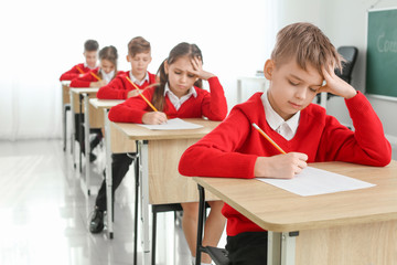 Pupils passing exam at school