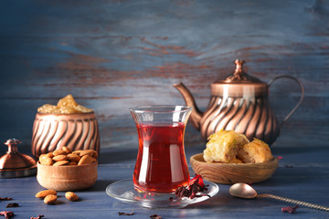 Tasty Turkish tea with sweets on table