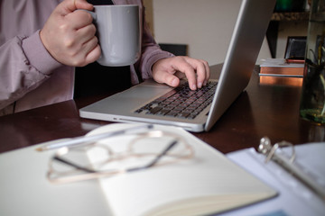man with pink jacket in a desktop working from home