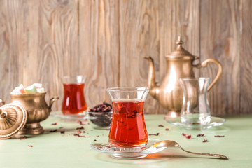 Glass of tasty Turkish tea on table