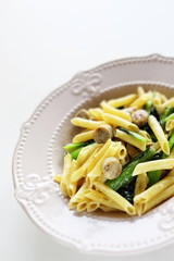 Italian food, penne and sausage with green leaf vegetable
