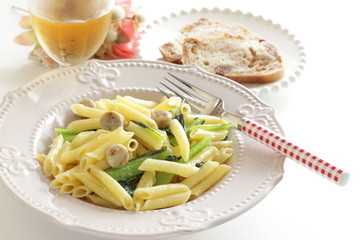 Italian food, penne and sausage with green leaf vegetable
