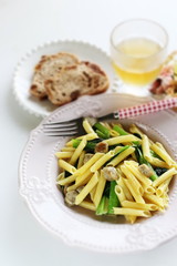 Italian food, penne and sausage with green leaf vegetable

