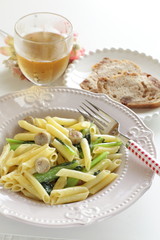 Italian food, penne and sausage with green leaf vegetable
