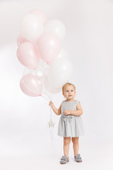 Little cute girl hold menu pink and white balloons enjoy festive  birthday event wear grey pastel summer dress rabbit-footwear isolated on a white background.