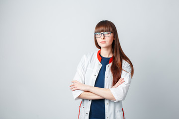 Smiling happy doctor pointing on blue background