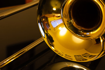 closeup of tenor trombone on the table - obrazy, fototapety, plakaty