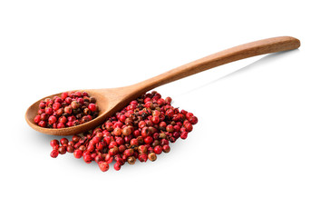 Red peppercorns in wooden spoon on a white background isolated. Natural spice and culinary flavor concept