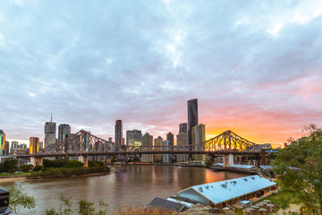 Fototapeta na wymiar Brisbane skyline with scraper with Story bridge at sunset pastel red golden and purple colors