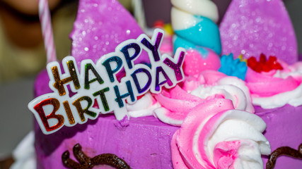 Happy birthday sign on colorful cake