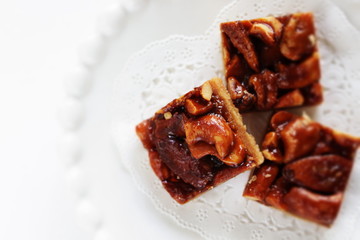 Mixed nuts and cookie on plate with copy space