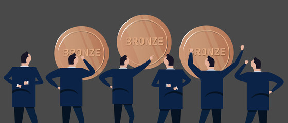 Obraz premium Employee businessman looking together at bronze coins concept of precious metal investment in business