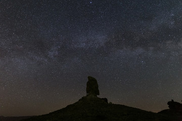 tufa formation under starry night sky and Milky Way at Trona Pinnacles, California