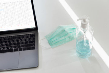 Medical mask next to a laptop