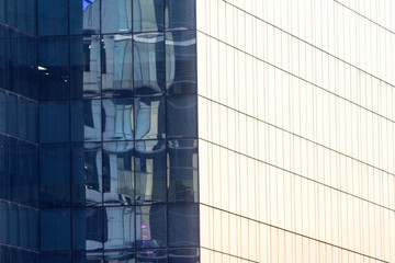 Night shot of bright neon lights reflecting off of glass facade of office buildings