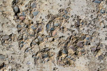 Old concrete wall for background. Small gravel falls out.