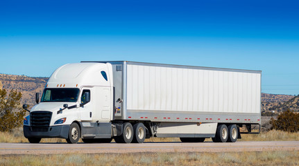 Eighteen wheel big rig tractor with trailer on highway. Trucking industry - 336575917