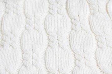 White knitted fabric texture, cables knitting stitches, soft woolen handmade cover, beautiful decorative design 