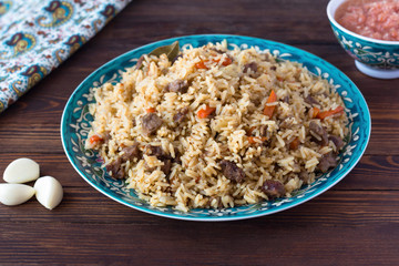 pilaf in a plate with a national pattern, Uzbek dishes, oriental cuisine