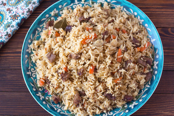 pilaf in a plate with a national pattern, Uzbek dishes, oriental cuisine, view from above