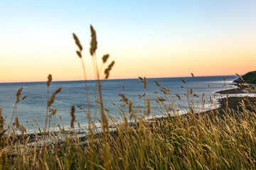 sunset on coastal cliff edge, beach, Hell's Mouth, Wales, UK