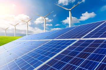 Solar panels with wind turbines on a sunny day,green clean energy concept.