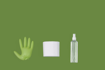 Sanitizer, a medical rubber glove and a toilet paper on the plain background