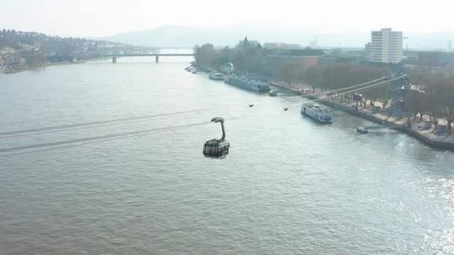 Cable car lift Seilbahn to the fortress ehrenbreitstein over the river rhine with a ship in Koblenz near Deusches Eck german corner panning drone aerial shot 4k 25p