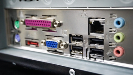 close up view of back PC computer connection panel detailed with many ports type and others sockets.