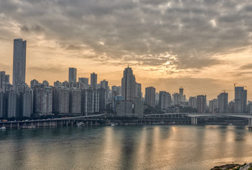 Fototapeta na wymiar Sunset over Jialing river with dense residence buiding in Chongqing, China