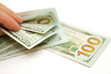 Man paying by Stack Of Paper Dollars Usa On The White Background
