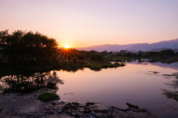 Fototapeta na wymiar The calm river at sunset