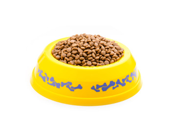 Dog food in yellow plastic bowl isolated on white