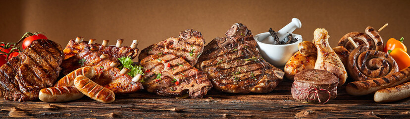 Selection of grilled gourmet meats on timber - obrazy, fototapety, plakaty