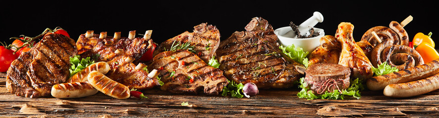 Various barbecued gourmet meats on timber board