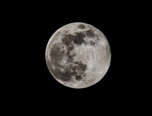 Full moon isolated on black sky background