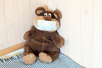 teddy bear in medical mask, home isolation 
