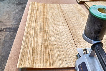 Oak veneer. Oak texture. Veneer splicing process with veneer hand splicer in woodshop