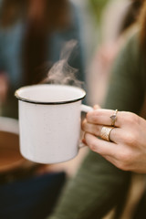 Fototapeta na wymiar woman holding a steaming mug of hot chocolate
