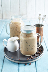 Iced coffee with milk, chocolate syrup and meringues.