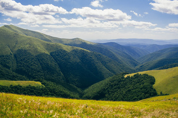 Fototapeta premium Beautiful Carpathians, mountains in clouds, waterfall, close-up, the sunsets beautifully over the mountains