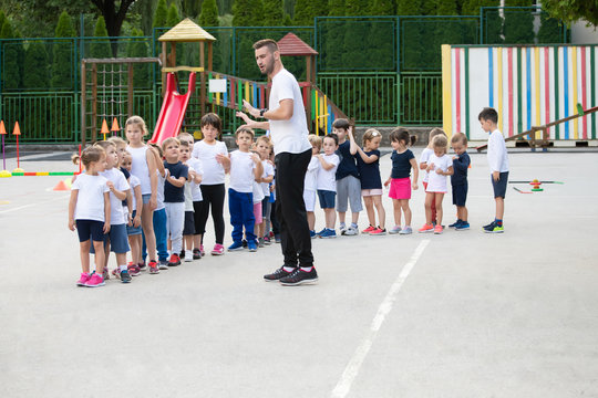 Group of children standing in column and waiting for lesson start.  Sport school